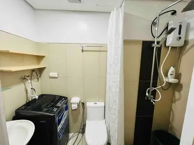 a small bathroom with a toilet and a sink at D Crib at Breeze Residences Pasay City Philippines in Manila