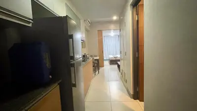 a hallway of a bathroom with a sink and a toilet at Full-Serviced Residential Apartment in One Uptown Residences, BGC in Manila
