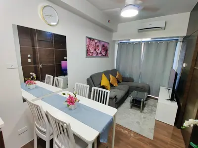 a living room with a table and a couch at Stunning 2BR Condo in AIR Residences Makati High Floor and WFH with 300Mbps Wifi in Manila