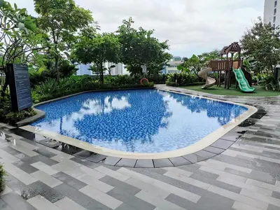 a swimming pool with a slide and a playground at Stunning 2BR Condo in AIR Residences Makati High Floor and WFH with 300Mbps Wifi in Manila