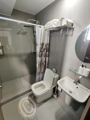 a bathroom with a toilet and a shower and a sink at Stunning 2BR Condo in AIR Residences Makati High Floor and WFH with 300Mbps Wifi in Manila