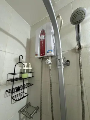 a shower in a bathroom with a shower head at Jazz Residences Tower B in Manila
