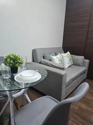 a living room with a couch and a table at Air Residences Makati Sage Haven in Manila