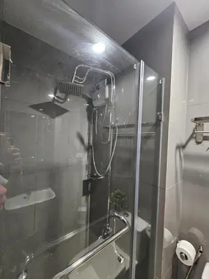 a shower in a bathroom with a glass door at Air Residences Makati Sage Haven in Manila