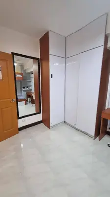 an empty room with white cabinets and a mirror at The Villa Staycation at La Verti Residences in Manila