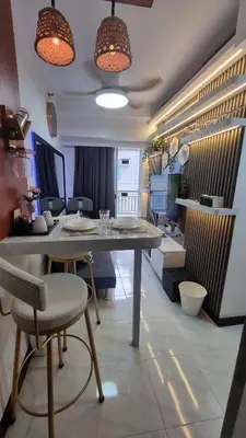 a dining room with a table and chairs in a room at The Villa Staycation at La Verti Residences in Manila
