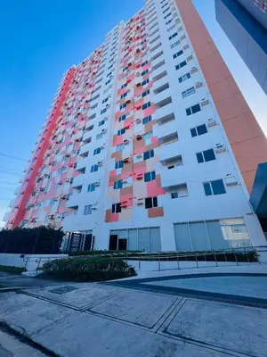 a tall apartment building with red and white at Tulip Garden Condominium Southwoods in Biñan