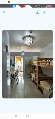 a room with two bunk beds and a chandelier at Shell Condotel MOA Pasay in Manila