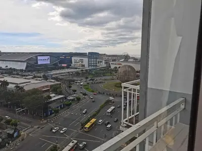 a view of a city street with cars on the road at Shell Condotel MOA Pasay in Manila