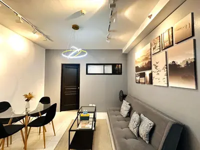 a living room with a couch and a table at Malate Bayview Mansion City View and Seaview Room in Manila
