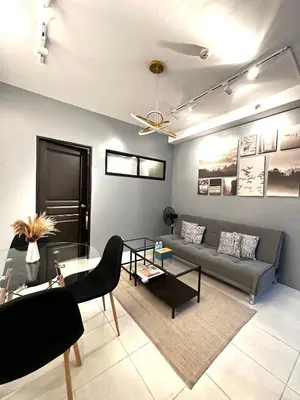 a living room with a couch and a table at Malate Bayview Mansion City View and Seaview Room in Manila