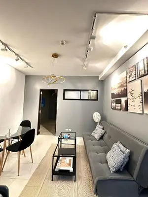 a living room with a couch and a table at Malate Bayview Mansion City View and Seaview Room in Manila