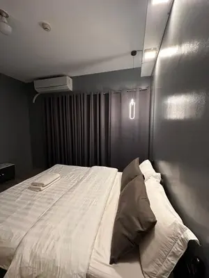 a bedroom with a large white bed in a room at Malate Bayview Mansion City View and Seaview Room in Manila