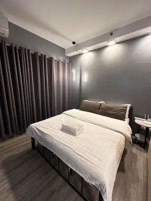 a bedroom with a large bed in a room at Malate Bayview Mansion City View and Seaview Room in Manila