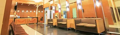 a waiting room with a row of chairs and mirrors at Spacious Cozy Corner in Manila