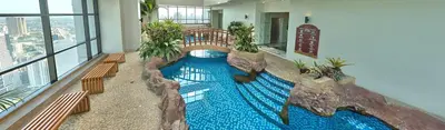 a large swimming pool in the middle of a building at Spacious Cozy Corner in Manila