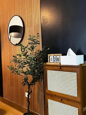 a mirror and a plant in a room at Meraki Stays - ISLA - SMDC Hope Residences in Trece Martires