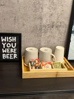 a tray with cups and other items on a table at Meraki Stays - ISLA - SMDC Hope Residences in Trece Martires