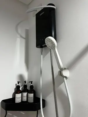 a room with a hair dryer and four bottles of hair products at Meraki Stays - ISLA - SMDC Hope Residences in Trece Martires