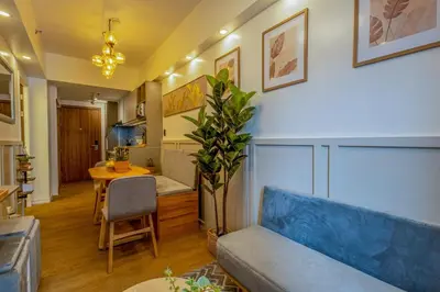 a living room with a couch and a table at Stylish Luxe 1 Bedroom Suite Near NAIA - FREE HIGH SPEED WIFI in Manila
