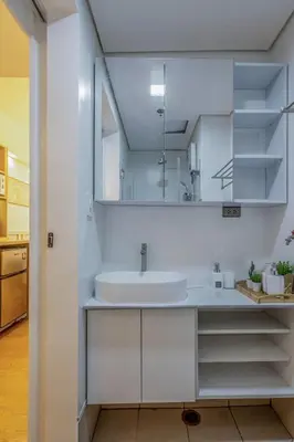 a white bathroom with a sink and a mirror at Stylish Luxe 1 Bedroom Suite Near NAIA - FREE HIGH SPEED WIFI in Manila