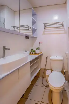 a bathroom with a toilet and a sink at Stylish Luxe 1 Bedroom Suite Near NAIA - FREE HIGH SPEED WIFI in Manila