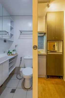 a bathroom with a toilet and a sink at Stylish Luxe 1 Bedroom Suite Near NAIA - FREE HIGH SPEED WIFI in Manila