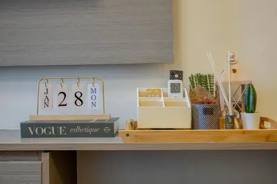 a shelf with a clock on top of a table at Stylish Luxe 1 Bedroom Suite Near NAIA - FREE HIGH SPEED WIFI in Manila