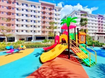 a playground in front of a large building at The Tropical Suite SMDC Hope Residence in Trece Martires