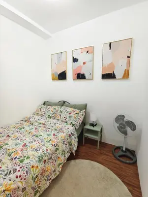 a bedroom with a bed and four pictures on the wall at Atmosphere You Secret Hideaway in Manila