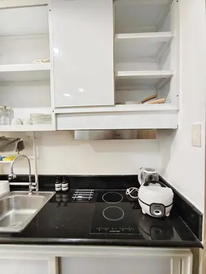 a kitchen counter with a toaster and a sink at Atmosphere You Secret Hideaway in Manila