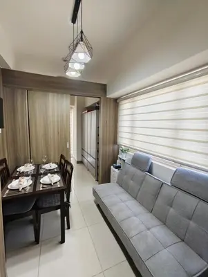 a living room with a couch and a table at Escape To Paradise in Manila