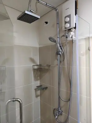 a shower with a shower head in a bathroom at Escape To Paradise in Manila