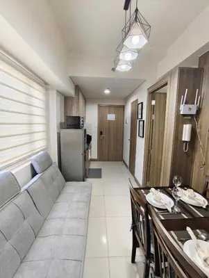a living room with a couch and a table at Escape To Paradise in Manila