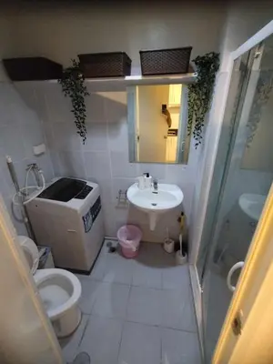 a small bathroom with a toilet and a sink at Cozy Room At Sea Residences in Manila