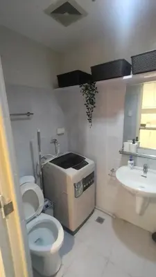 a bathroom with a toilet and a sink at Cozy Room At Sea Residences in Manila