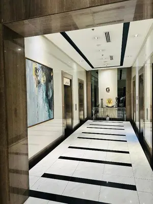 a hallway with black and white flooring in a building at We Vibe, 81 Newport Blvd across NAIA 3 in Manila