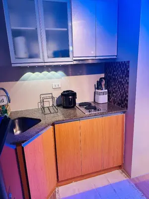a kitchen with a sink and a counter top at We Vibe, 81 Newport Blvd across NAIA 3 in Manila