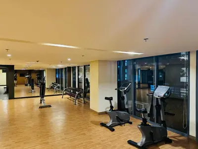 a gym with treadmills and exercise equipment in a building at We Vibe, 81 Newport Blvd across NAIA 3 in Manila