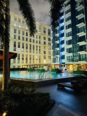 a large swimming pool in front of a building at We Vibe, 81 Newport Blvd across NAIA 3 in Manila