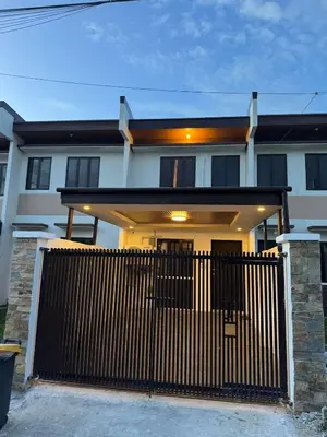 a white house with a wooden fence in front of it at Casa Mira in Dasmariñas