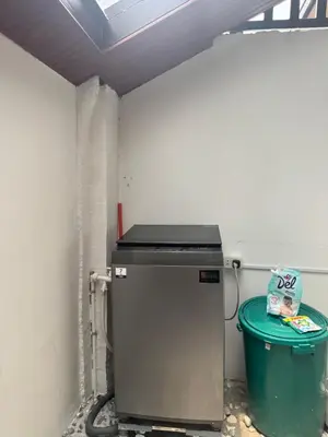 a small refrigerator in a room with a trash can at Casa Mira in Dasmariñas
