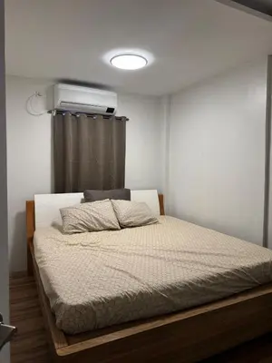 a bedroom with a bed with a air conditioner on the wall at Casa Mira in Dasmariñas