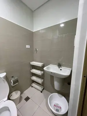 a bathroom with a sink and a toilet at Apartment in Pasay in Manila