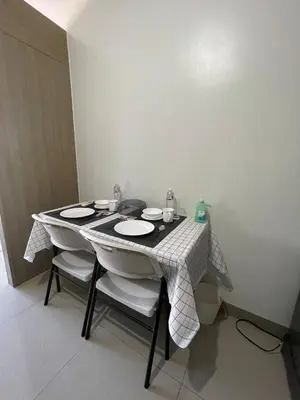 a table with two plates on it in a room at Apartment in Pasay in Manila