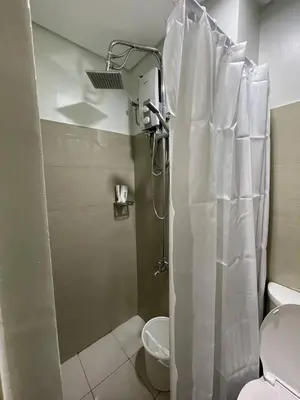 a bathroom with a shower with a shower curtain at Apartment in Pasay in Manila