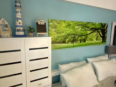 a bedroom with a white dresser and a painting on the wall at Cozy Home Right Across International Airport Terminal 3 in Manila