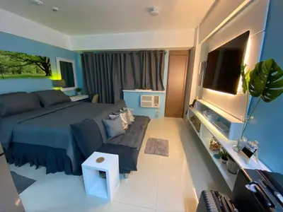 a bedroom with a bed and a couch at Cozy Home Right Across International Airport Terminal 3 in Manila
