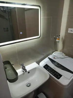 a bathroom with a sink and a mirror at Jasmine Haven in Shore2 Residences in Manila