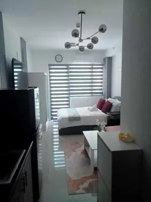 a living room with a bed and a couch at Jasmine Haven in Shore2 Residences in Manila